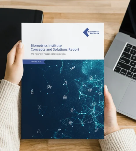 Woman holding a Biometrics Concepts and Solutions report featuring case studies from Biometrics Institute members on the future of responsible biometrics